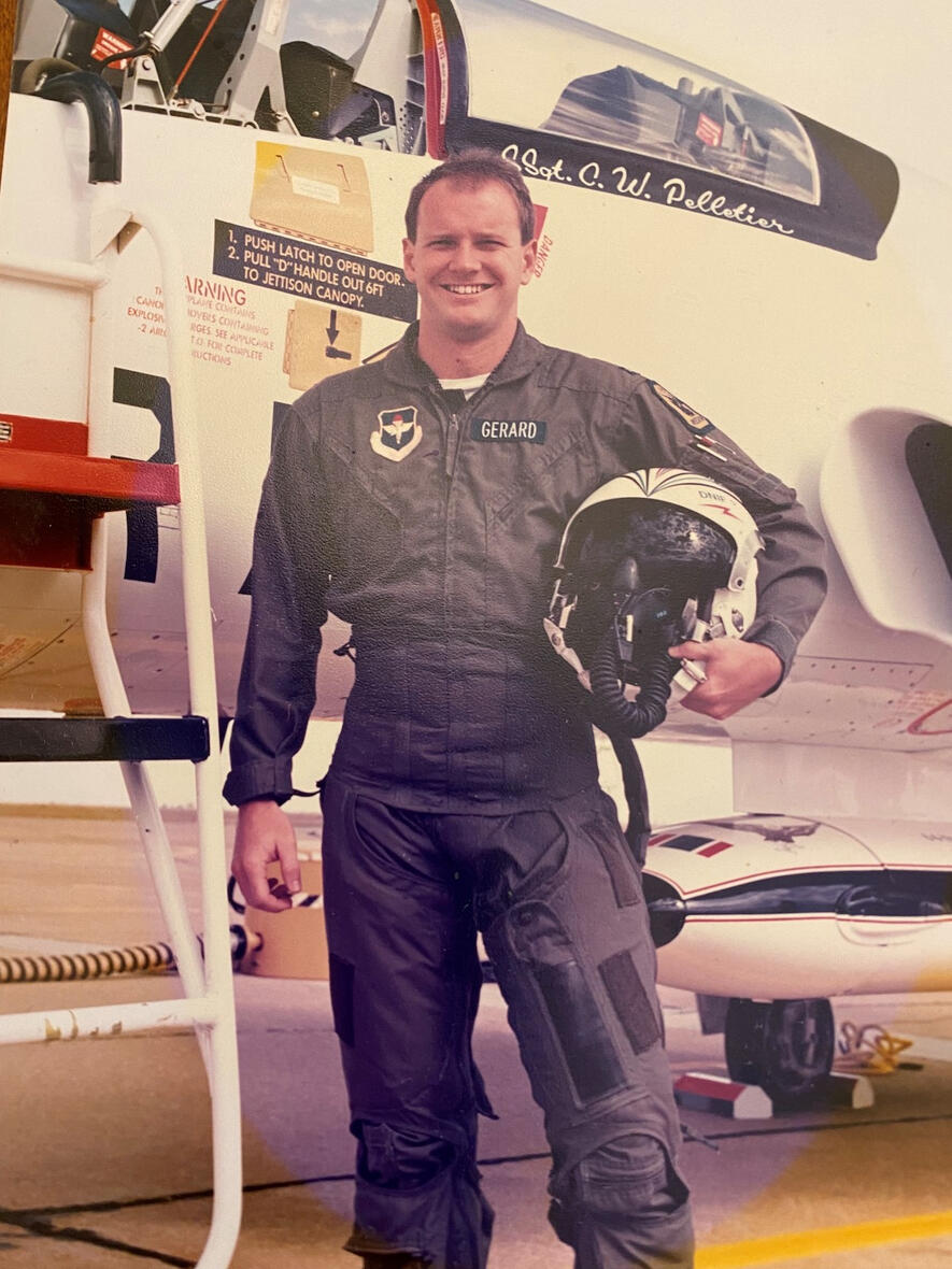 Don Gerard Standing in Air Force Gear in front of a Jet
